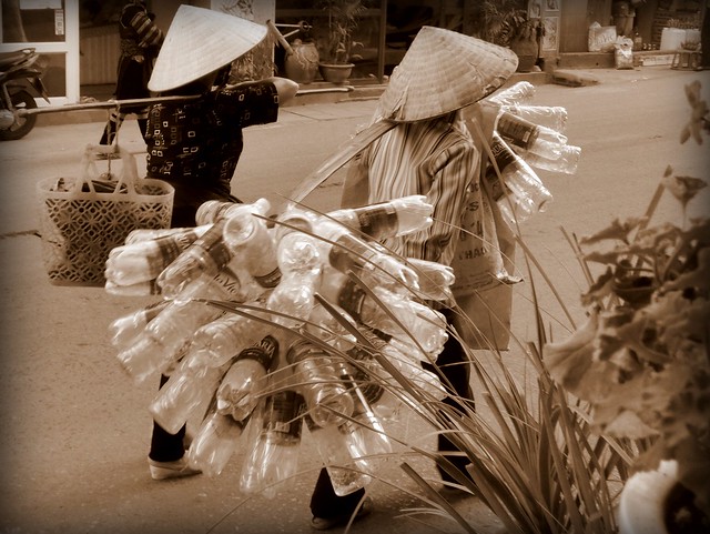 Women in conical hats walking the streets of Sapa, Vietnam