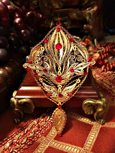detailed red and gold quilled ornament