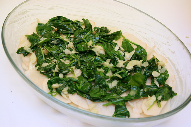 Spread the garlicky spinach on the potatoes