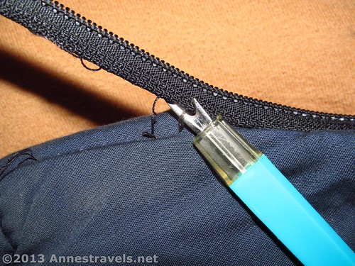 Ripping out the old zipper on a sleeping bag to replace the broken zipper