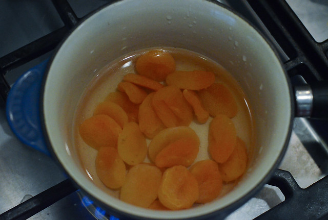 Dried apricots in a saucepan with water.