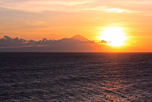 the sun starts to tuck itself behind Bali's volcano