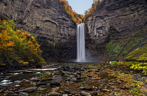 travel autumn cliff newyork fall tourism nature water colors creek river outside outdoors landscapes high scenery colorful stream colours seasons seasonal relaxing scenic calming large parks environmental peaceful wallart calm canyon rockface fallfoliage waterfalls valley cascades area environment gorge serene tall colourful ithaca fingerlakes chasm senecalake stateparks taughannockfalls leafchange treesleaves taughannockfallsstatepark senecariver
