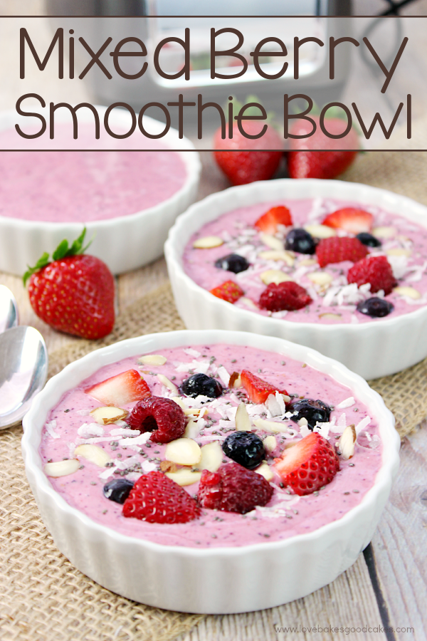 Mixed Berry Smoothies in three white bowls with fresh fruit.