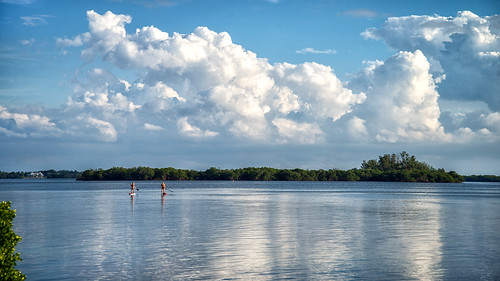 water up clouds stand board paddle paddleboarding