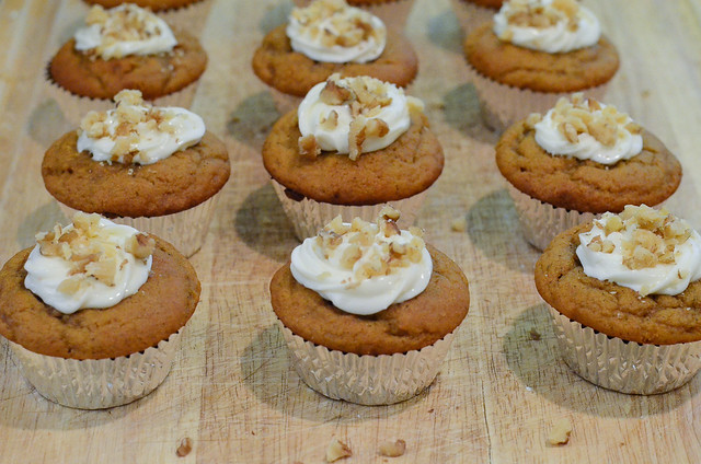 The cupcakes are garnished with chopped walnuts.
