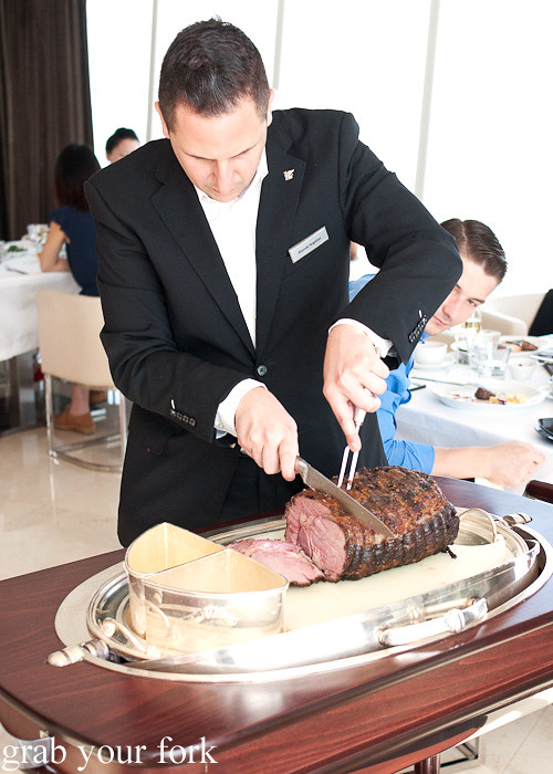 Waiter carving the US prime rib tableside during Friday brunch at Prime 68, JW Marriott Marquis Dubai