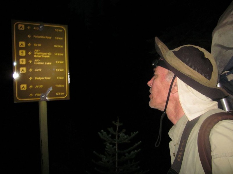 Checking trail signs in the dark at the Johnston Creek Trail junction - 0.5km to our campsite at JO29
