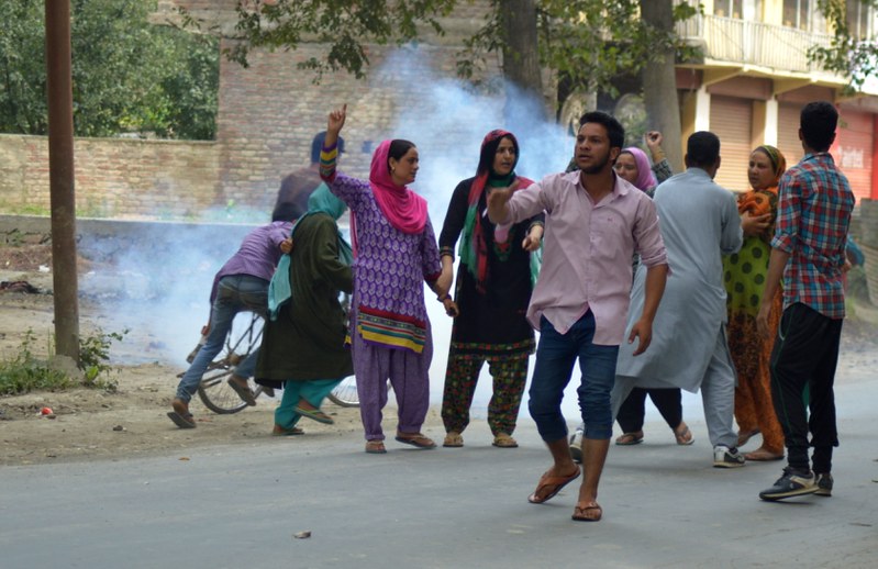 Womens run for shelter as police fires tear gas shells