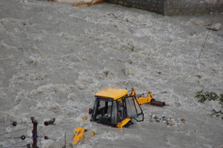 An earth mover trapped in a raging river, the Bhagirathi