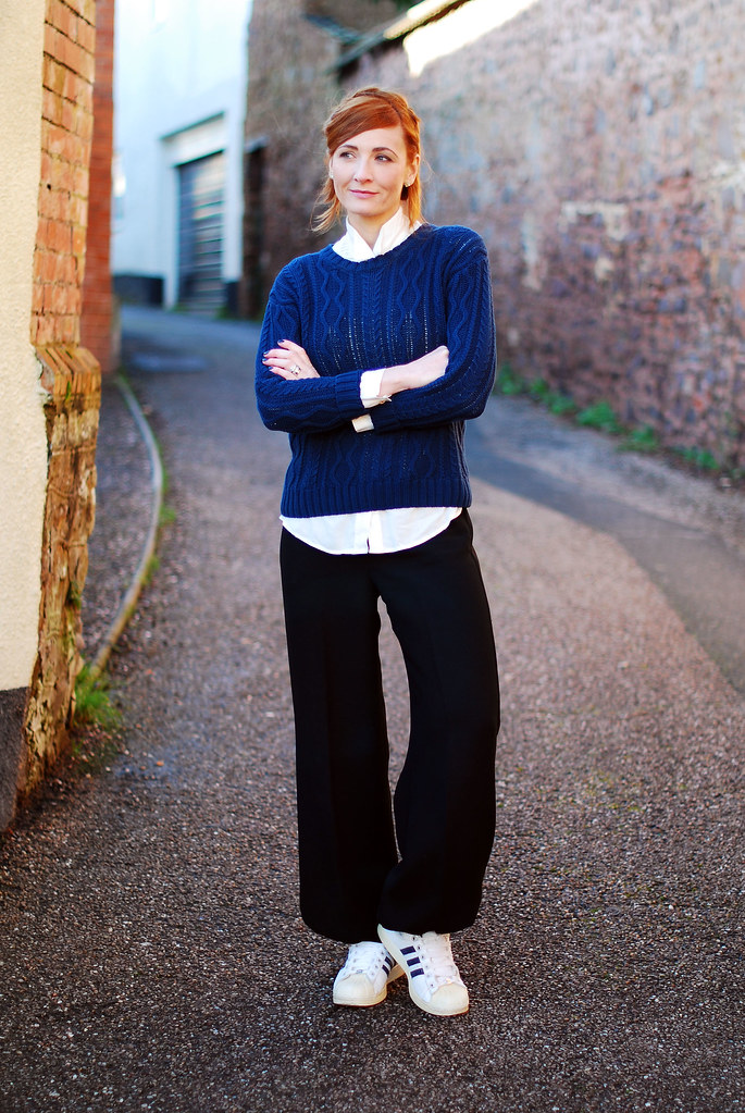 Navy sweater, loose black trousers & Adidas