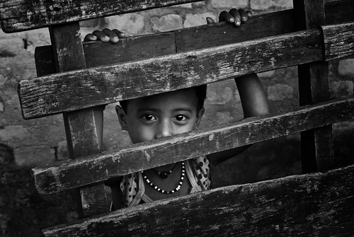 travel nepal portrait people blackandwhite bw travelling monochrome rural fence asian eyes asia village child looking candid portraiture nepalese curious cart staring chitwan nepali sauraha southasia southasian travelphotography candidportraiture chitwandistrict chitwanvalley