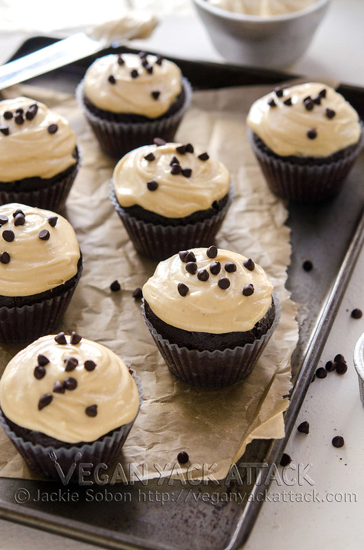 Chocolate cupcakes on a baking sheet lined with parchment paper