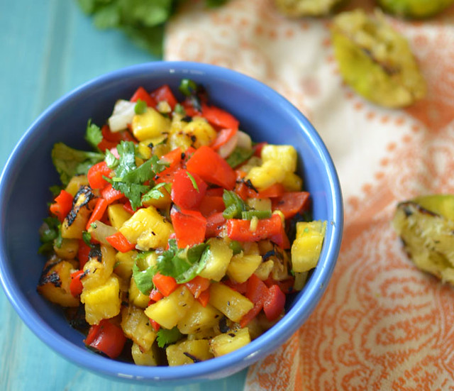 Sweet and smoky grilled pineapple salsa with charred pineapple, jalapeno, peppers and fresh herbs is perfect over grilled salmon for your summer BBQ!