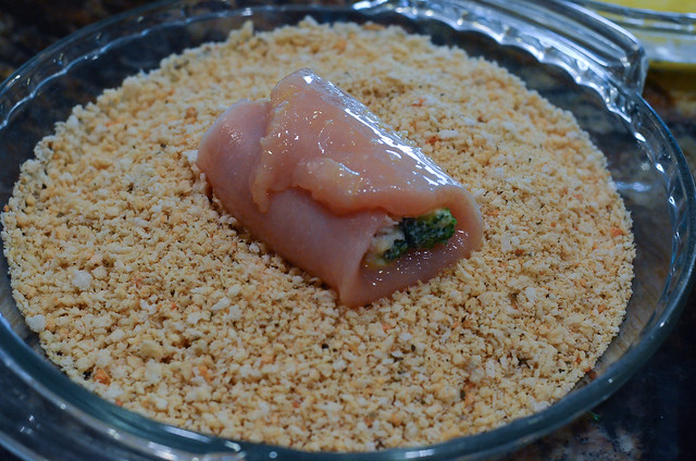 The egg coated chicken is dipped in panko bread crumbs in a separate pie dish.