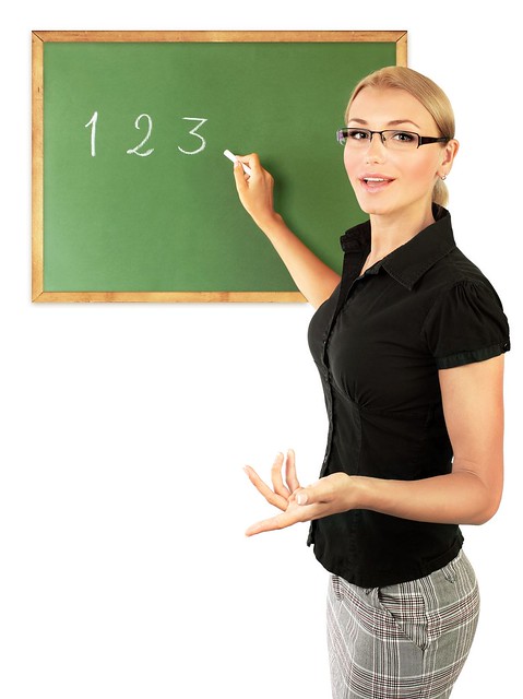 young-teacher-writing-numbers-on-the-chalkboard-isolated-on-white-background- from Flickr via Wylio