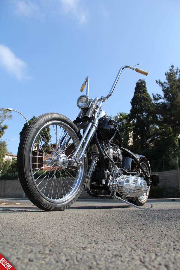 A photo of the front and right side of the black bike featuring the bike's front tire