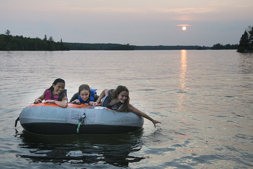 girls friends sunset sky lake ontario canada tourism water childhood horizontal fun outdoors evening togetherness child friendship dusk tourist inflatable leisure relaxation playful vacations enjoyment lifejacket scenics lakeofthewoods frontview lifestyles watersurface threepeople leisureactivity keewatin inflatableraft childrenonly earlyteens floatingonwater preadolescentchild onlygirls