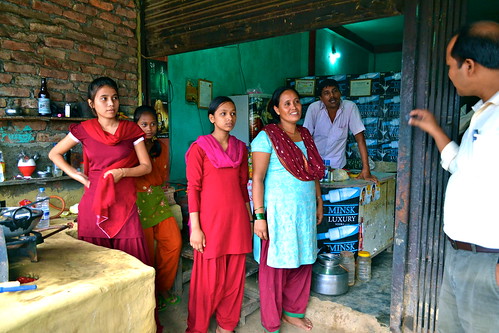 BASE employer explaining the law regrading kamlari practice to local restaurant owner in the Kailali district. Suman Chaudhary, a "15" year old Tharu girl, who works for this family is sitting in the back in a green and orange outfit.