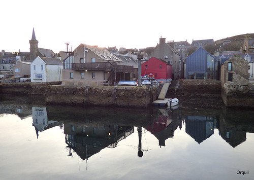 stromness town reflections march spring seaside waterfront shoreline flatcalm noripples sea mirrorimage calm windless evening lowtide slipway piers launch moored mostly traditional old buildings twostorey houses kirk church steeple skyline silhouette hillside redshed harbour lights greysky orkney islands scotland uk unitedkingdom greatbritain orcades unusual quaint interesting scenic attractive historic