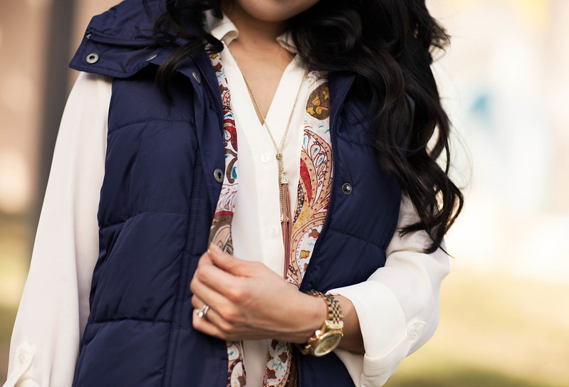 cute & little blog | navy quilted puffer vest, white blouse, tassel necklace, paisley scarf, skinny jeans | fall trend layering outfit
