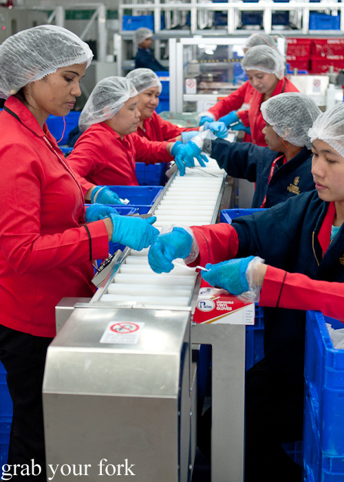 Preparing Economy Class cutlery packs during a behind-the-scenes tour of Emirates Flight Catering