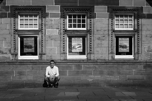 monochrome people urban street candid portrait streetphotography candidstreetphotography streetlife urbanlandscape man male face facial expression look emotion feeling eyecontact candideyecontact smoke smoker smoking cigarette perched sitting crouch composition framing minimalism minimalist symmetry symmetrical three windows tone texture detail depth naturallight outdoor sunlight light shade shadow city scene human life living humanity society culture architecture canon canon5d 5dmarkiii 70mm character ef2470mmf28liiusm black white blackwhite bw mono blackandwhite glasgow scotland uk