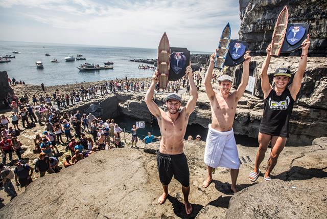 Gary Hunt (C) of the UK celebrates on the podium with 2nd placed Steven LoBue (L) of the USA and 3rd placed Jonathan Paredes (L) of Mexico after the third stop of the Red Bull Cliff Diving World Series, Inis Mor, Aran Islands, Ireland on June 29th 2014.  