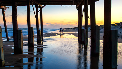ocean sunset beach pier couple walk obx