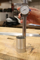 Dial calipers measuring depth of a hole