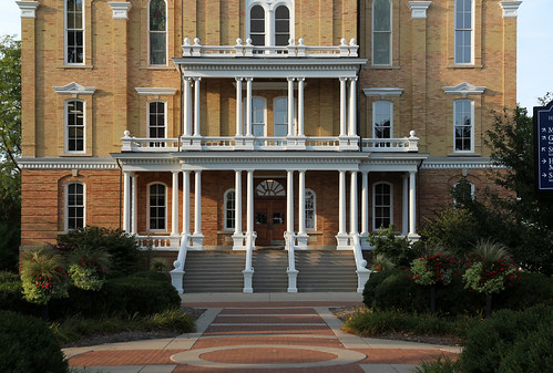 county trees windows building brick college evening hall landscaping michigan central columns steps structure historic sidewalk porch classical ornate bays twostory bushes 44 hillsdale doric ionic balustrade cornice 1875 italianate recessed dentils pediments segmentalarched