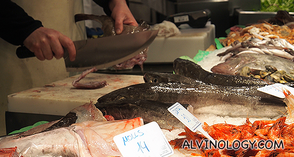 Chopping up a fresh fish for the customer 