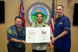 Maui County Lifeguard Keoki Pfaeltzer was awarded a Certificate of Valor by Capt. Shannon Gilreath, Coast Guard Sector Honolulu commanding officer and Maui Mayor Alan Arakawa in an award ceremony held at the Maui County Mayor's Office, May 30, 2014. Pfaeltzer was recognized for his efforts in rendering assistance to a distressed snorkeler off the shores of Ma'alaea Bay, Maui, June 14, 2013. U.S. Coast Guard photo by Lt. Kevin Cooper