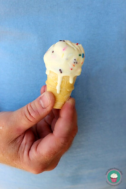 Lemon Funfetti Ice Cream in ice cream cone being held in hand.