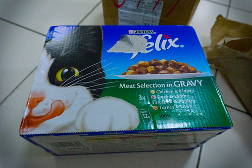 Second hand camera lens in cat food box