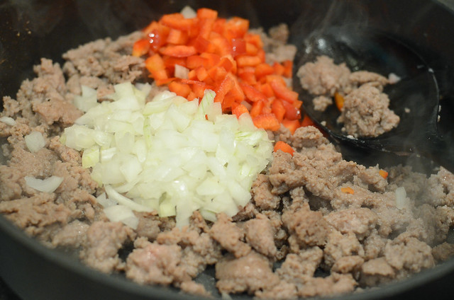 Ground turkey, onion and red bell pepper in a skillet.