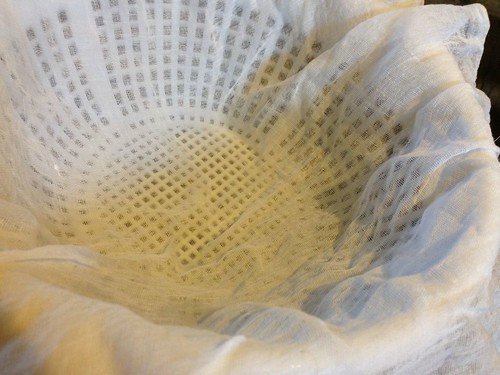 cheesecloth-lined white colander