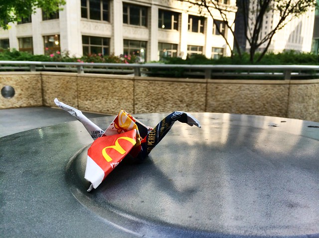 McDonalds bag origami atop garbage can