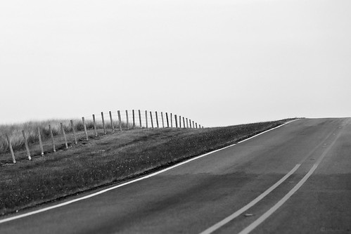 janbuchholtz driveby highway road blacktop 2lane nopassing fence monochrome highway159 texas travel lonely