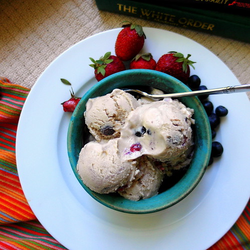 A serving of Fruit Dip Ice Cream with a spoon. Whole berries garnish the serving.