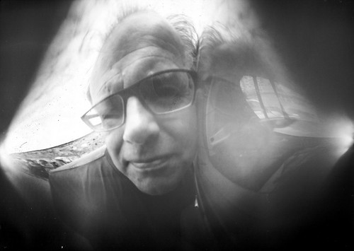Self-portrait with a pinhole camera made from a beer can