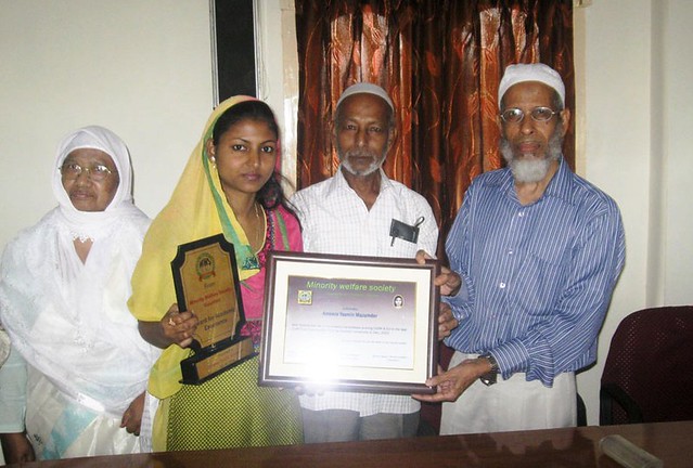 Ameera Yasmin Mazumder (2nd from L) who topped the list of successful candidates of the LL M examination of Gauhati University (2013), receiving certificate and plaque from the hands of Abdul Hoque, former Commissioner & Secretary Law, Govt of Assam at a