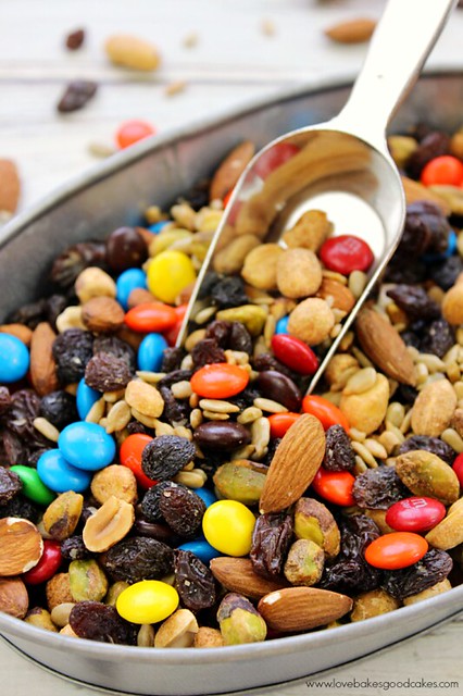 Sweet & Salty Trail Mix in a metal pan with a scoop in the middle.