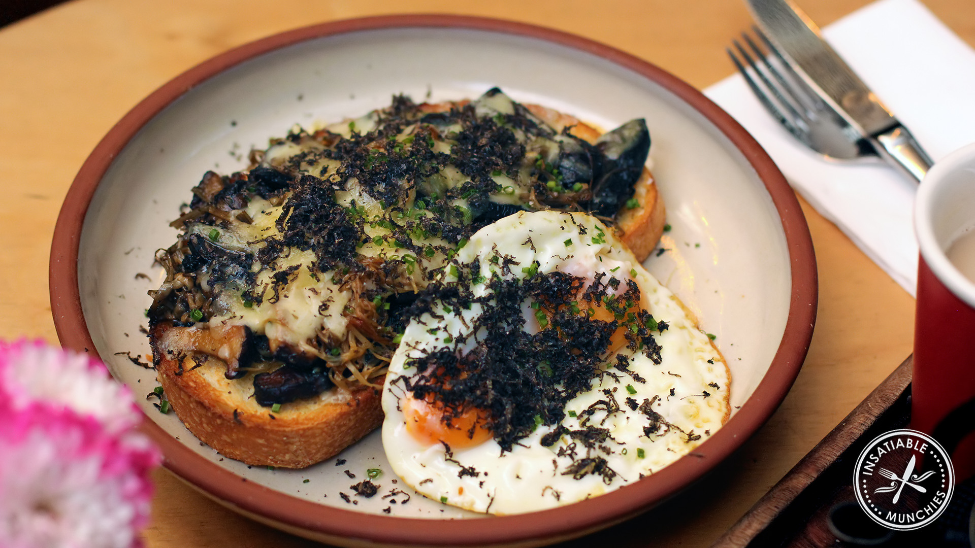 Ultimate toastie: mixed mushrooms laid on thick toasted sourdough, with melted cheese, and a side of sunny side up eggs. Topped with grated truffles. 
