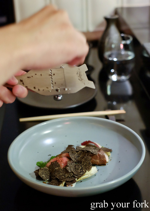 Chef Chase Kojima shaving truffles onto the wagyu oyster blade at Sokyo at The Star, Pyrmont