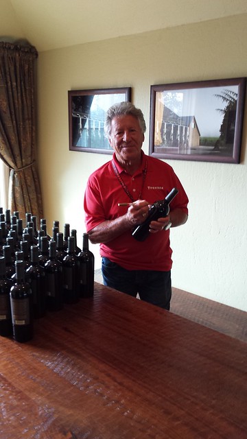 Mario Andretti signing Andretti Winery bottles for WCLM