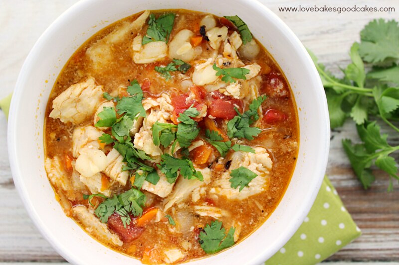 Slow Cooker Chicken Posole in white bowl with cilantro top view