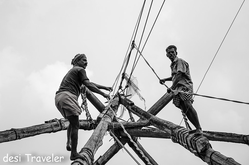 Fishermen working on Chinese Fishing nets Fort Kochi Cochin 