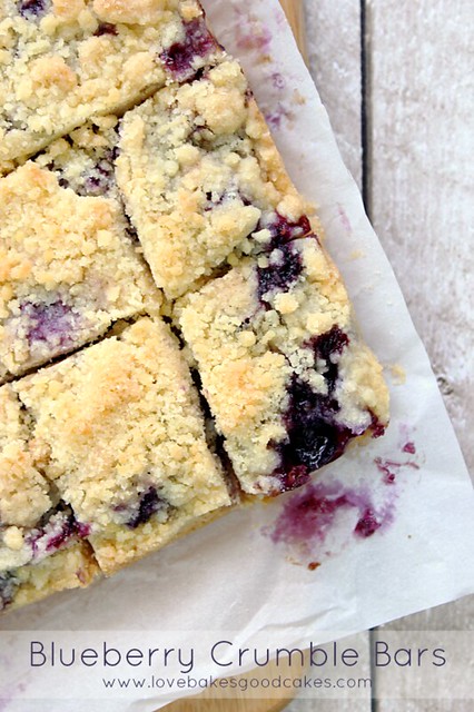 Blueberry Crumble Bars cut into squares on white plate.