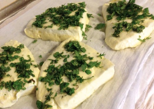 four wedges of haloumi with lots of chopped mint on them